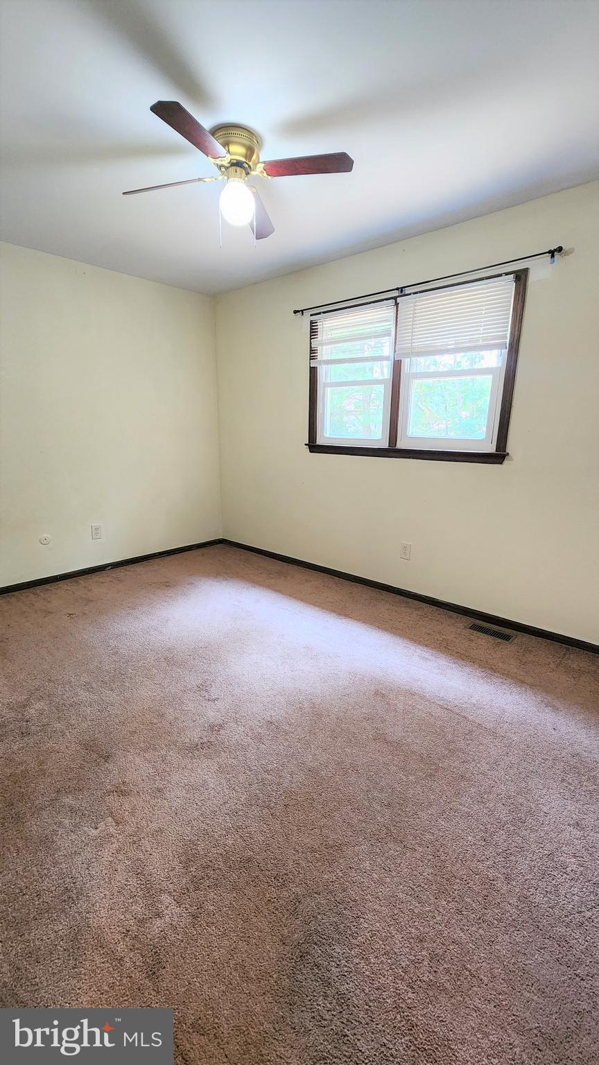 408 Deptford Road Glassboro, NJ 08028 - Photo 8 of 13 an empty room with windows and fireplace