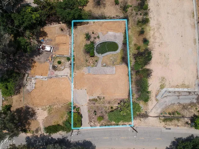 an aerial view of a house with a yard