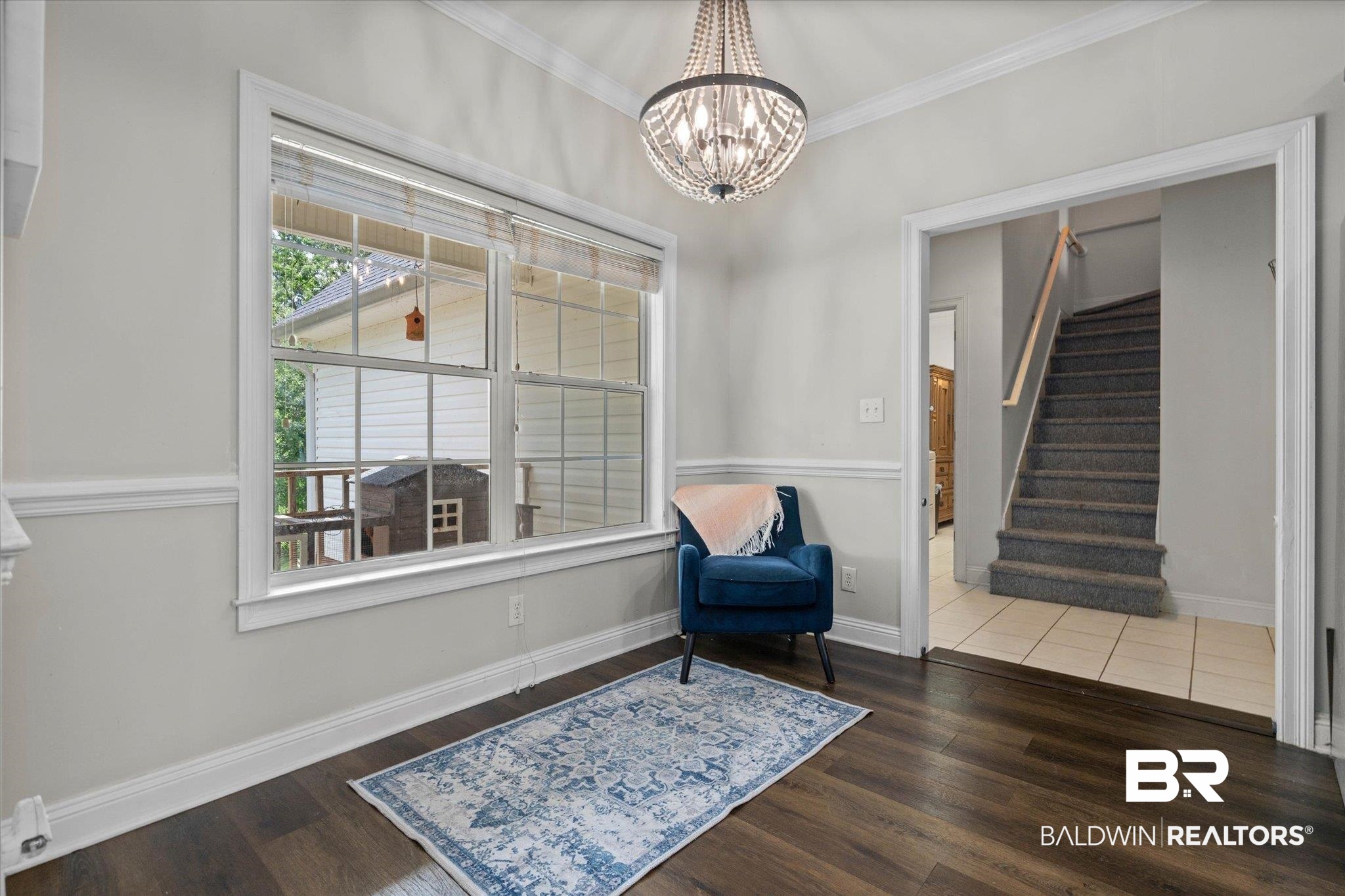 22760 Ridgewood Drive Robertsdale, AL 36567 - Photo 8 of 44 Living area featuring ornamental molding, stairway, wood finished floors, and a chandelier