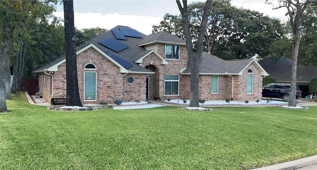 1449 Spinnaker Lane Azle, TX 76020 - Photo 1 of 23 a front view of a house with a garden and trees