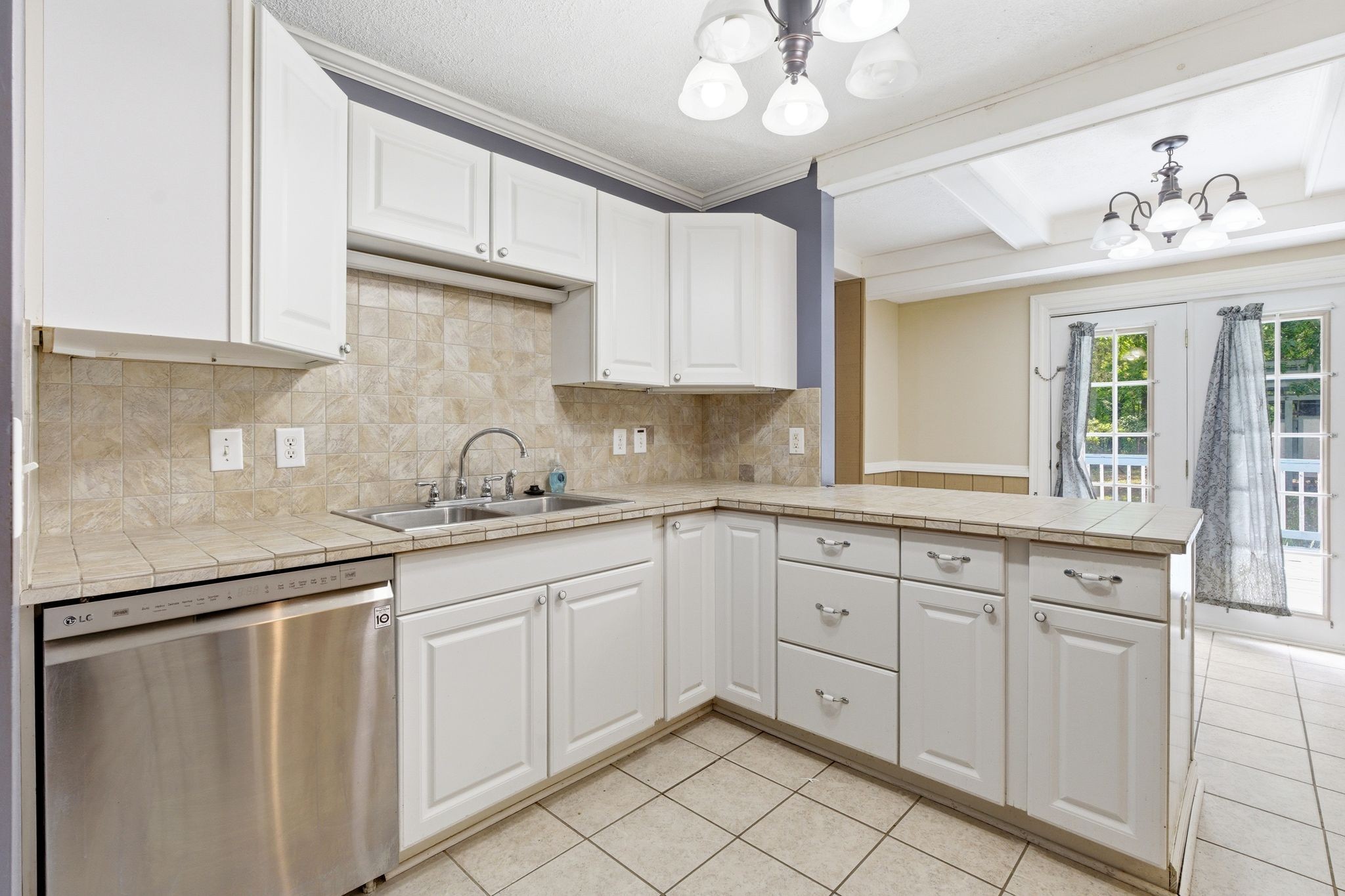 6603 Shedden Road Greenbrier, TN 37073 - Photo 10 of 30 a kitchen with white cabinets and chandelier