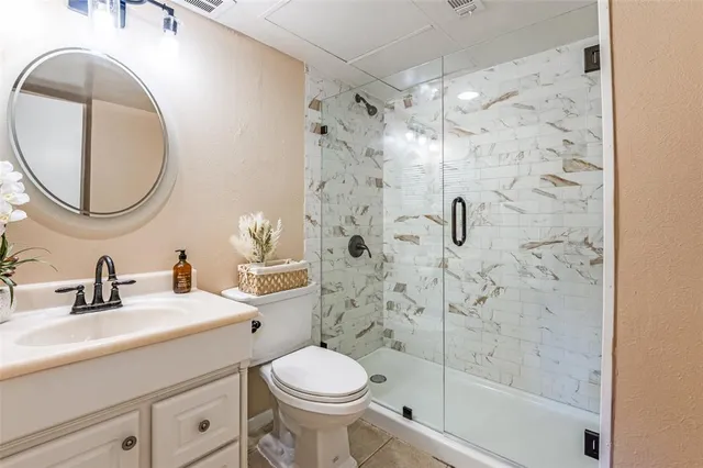 a bathroom with a sink a toilet and shower