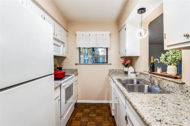 a kitchen with a sink and a stove top oven