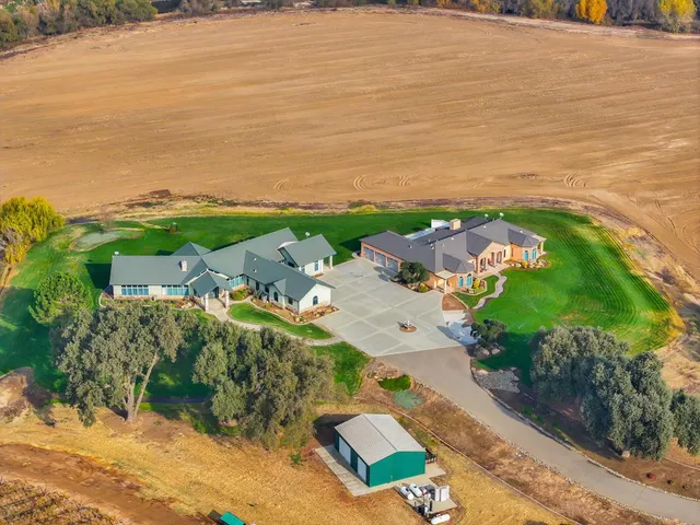 a front view of a house with a garden and yard