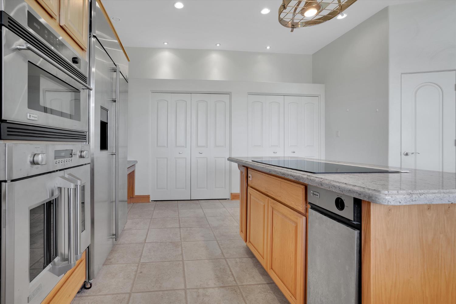 20170 River Road Stevinson, CA 95374 - Photo 18 of 77 a kitchen with stainless steel appliances granite countertop a stove a sink and a microwave