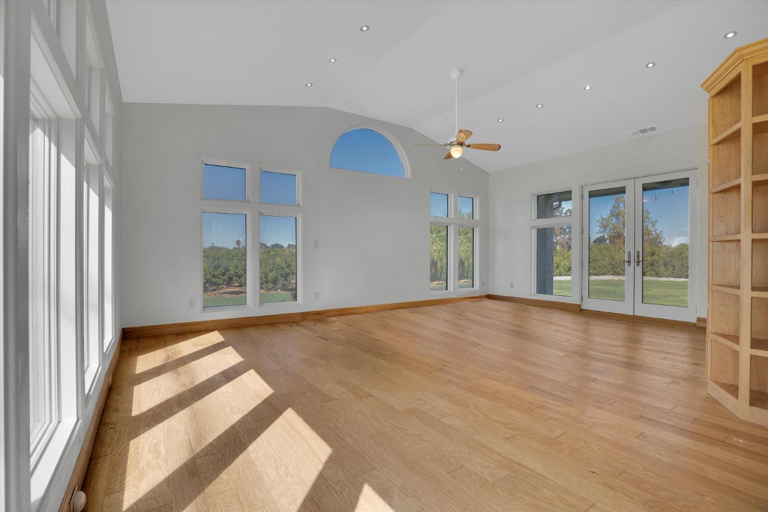 20170 River Road Stevinson, CA 95374 - Photo 19 of 77 a view of an empty room with wooden floor and a window