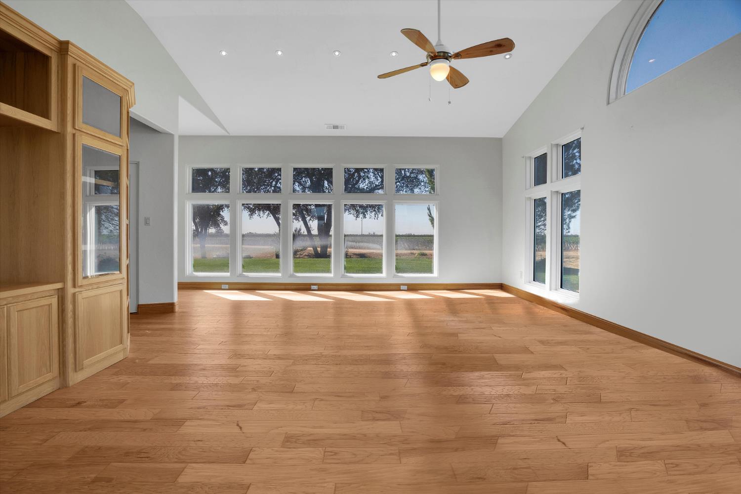 20170 River Road Stevinson, CA 95374 - Photo 21 of 77 a view of an empty room with a window and chandelier fan