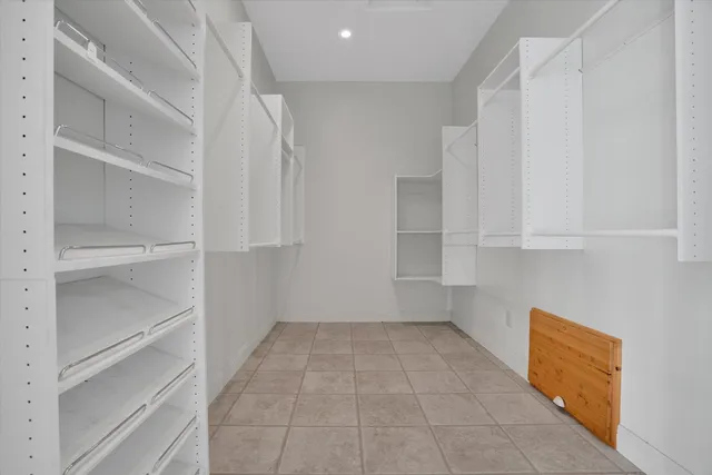 a view of walk in closet with empty racks