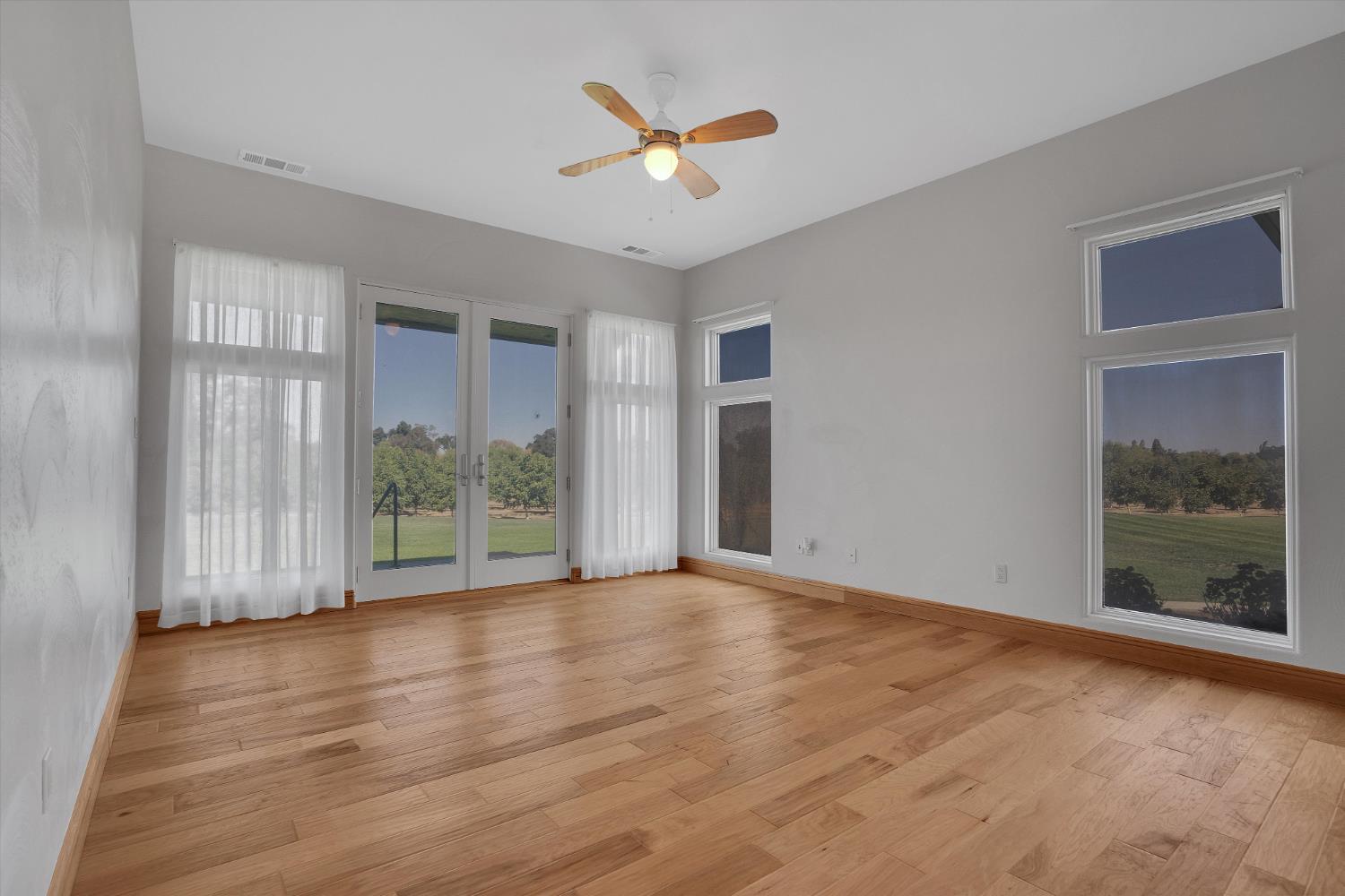 20170 River Road Stevinson, CA 95374 - Photo 33 of 77 a view of an empty room with a window and a ceiling fan