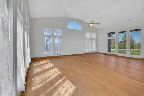 a large kitchen with stainless steel appliances kitchen island granite countertop a stove a sink a refrigerator and a cabinets