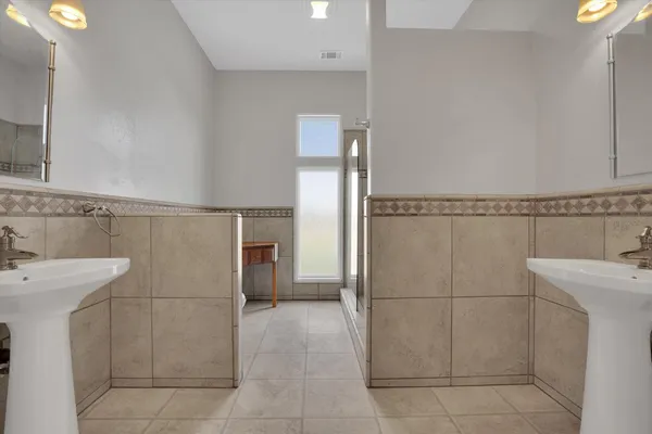 a kitchen with stainless steel appliances granite countertop a sink a stove and a wooden floors