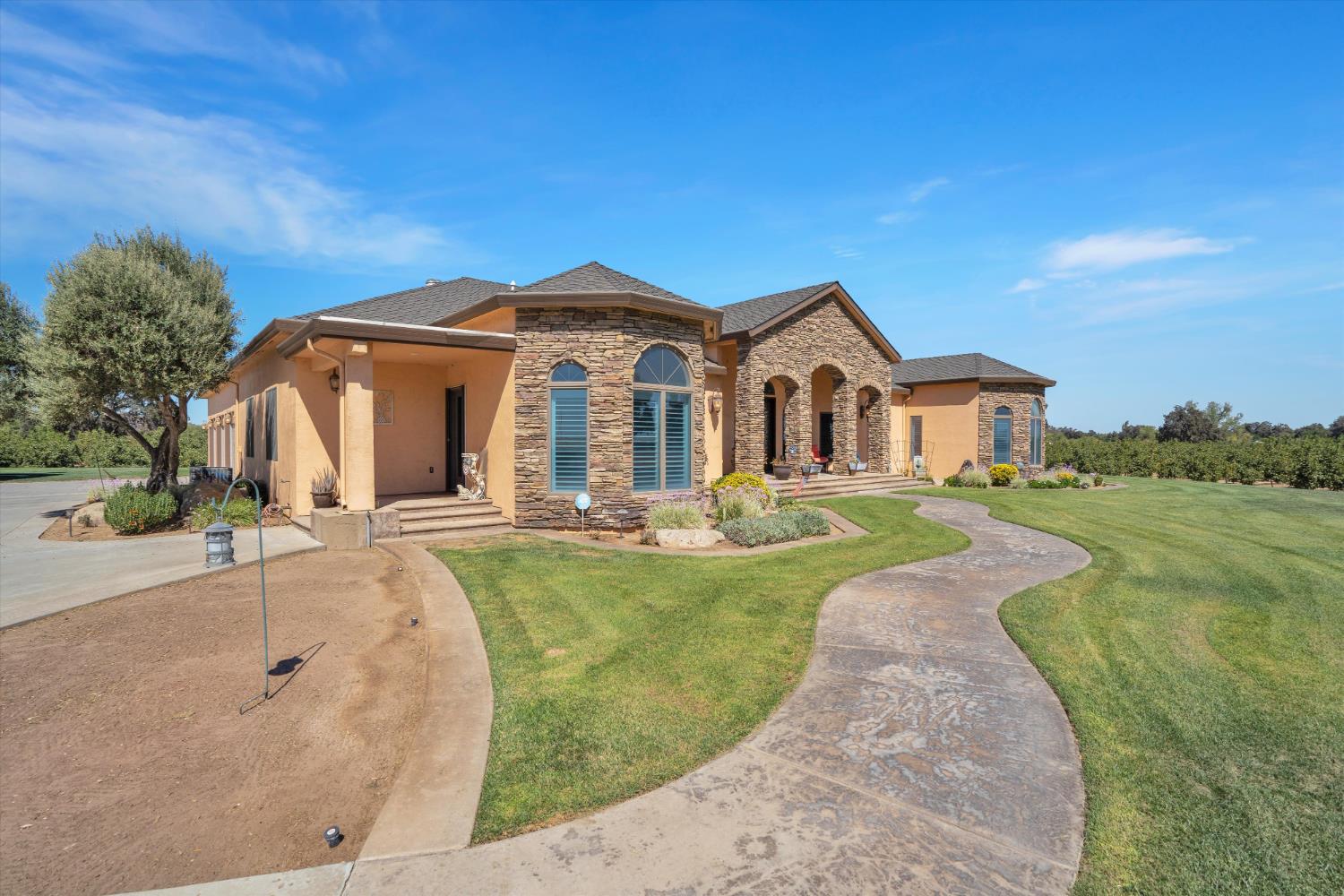 20170 River Road Stevinson, CA 95374 - Photo 37 of 77 a front view of a house with garden