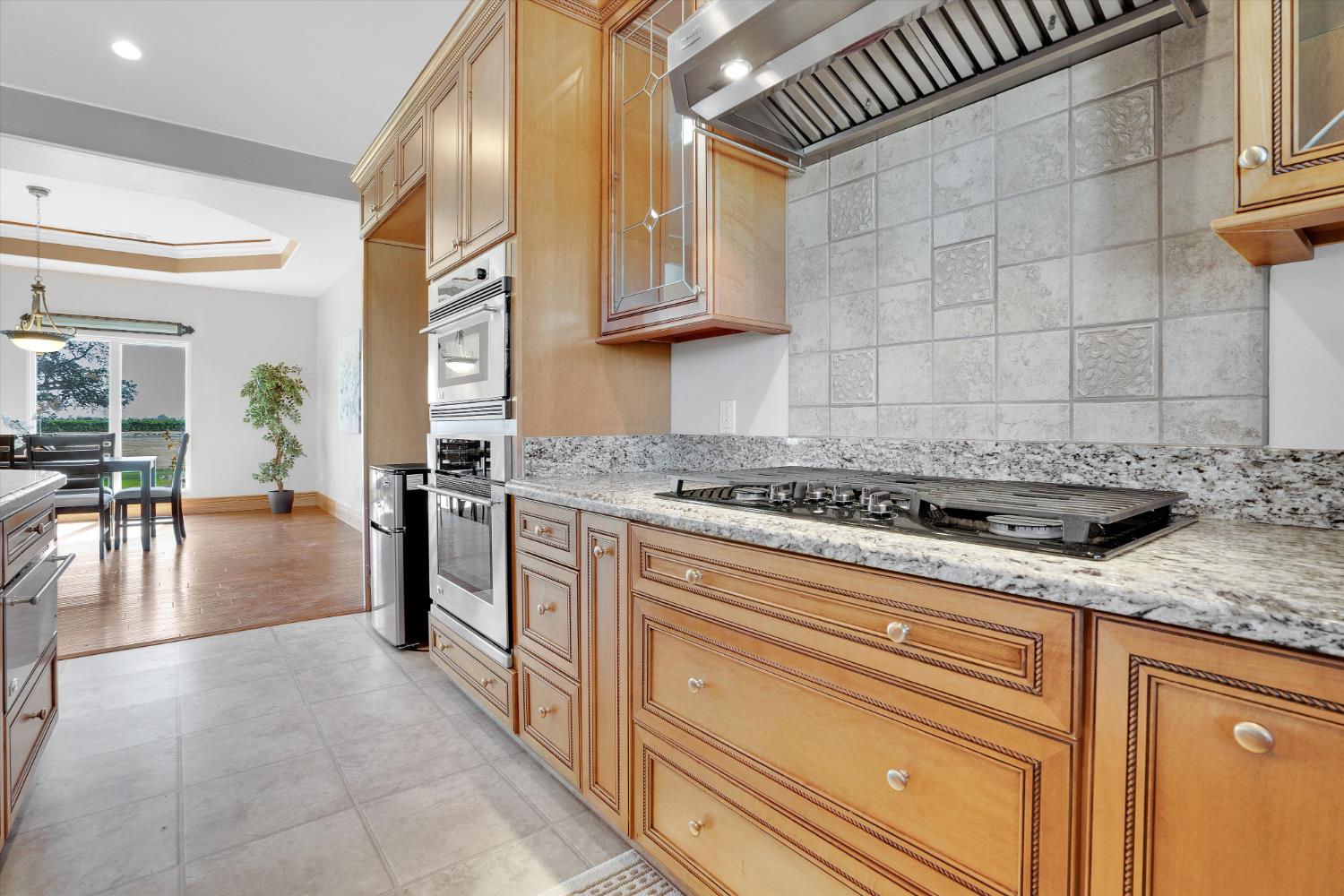 20170 River Road Stevinson, CA 95374 - Photo 53 of 77 a kitchen with stainless steel appliances granite countertop a sink stove and cabinets