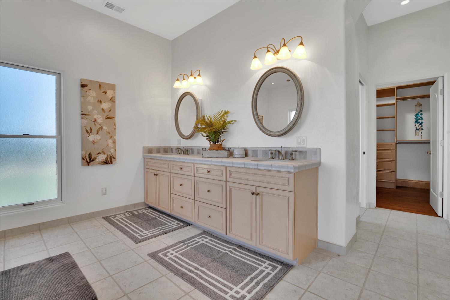 20170 River Road Stevinson, CA 95374 - Photo 59 of 77 a bathroom with a double vanity sink and a mirror