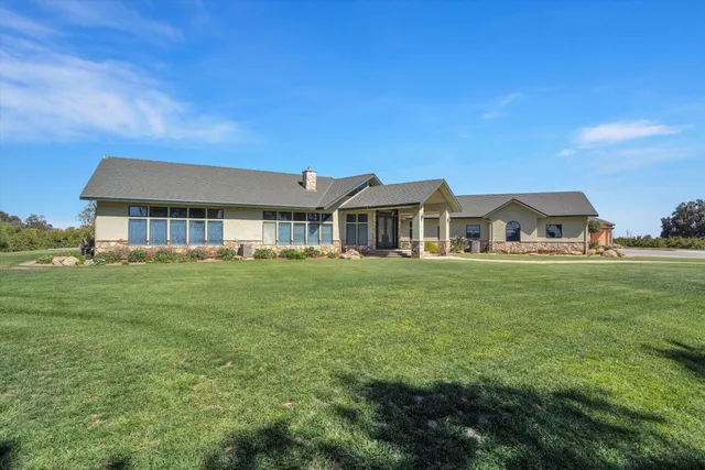 a kitchen with stainless steel appliances granite countertop a stove top oven a sink a counter space and cabinets