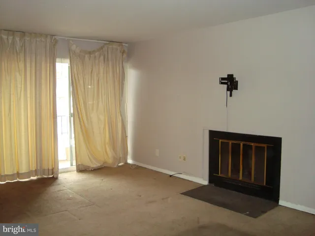 a view of empty room with a fireplace