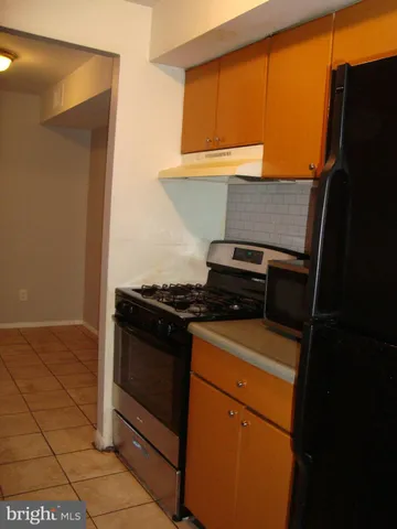 a stove top oven sitting inside of a kitchen