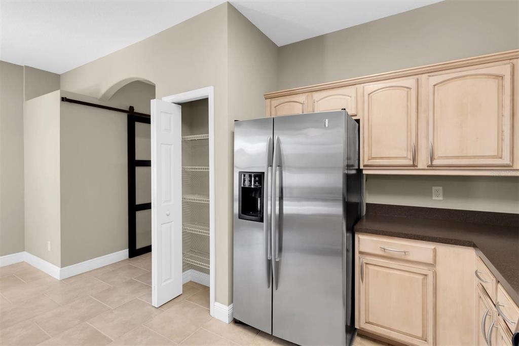 10121 Porch Street New Port Richey, FL 34655 - Photo 12 of 57 a metallic refrigerator freezer sitting in a kitchen