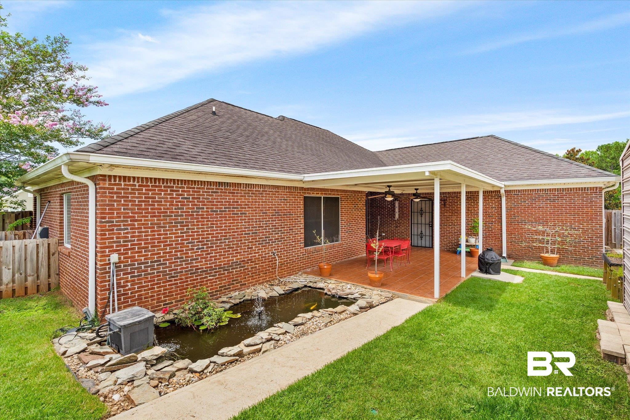 1561 William Dunn Way Mobile, AL 36695 - Photo 22 of 28 Back of house with ceiling fan, a lawn, and a patio area