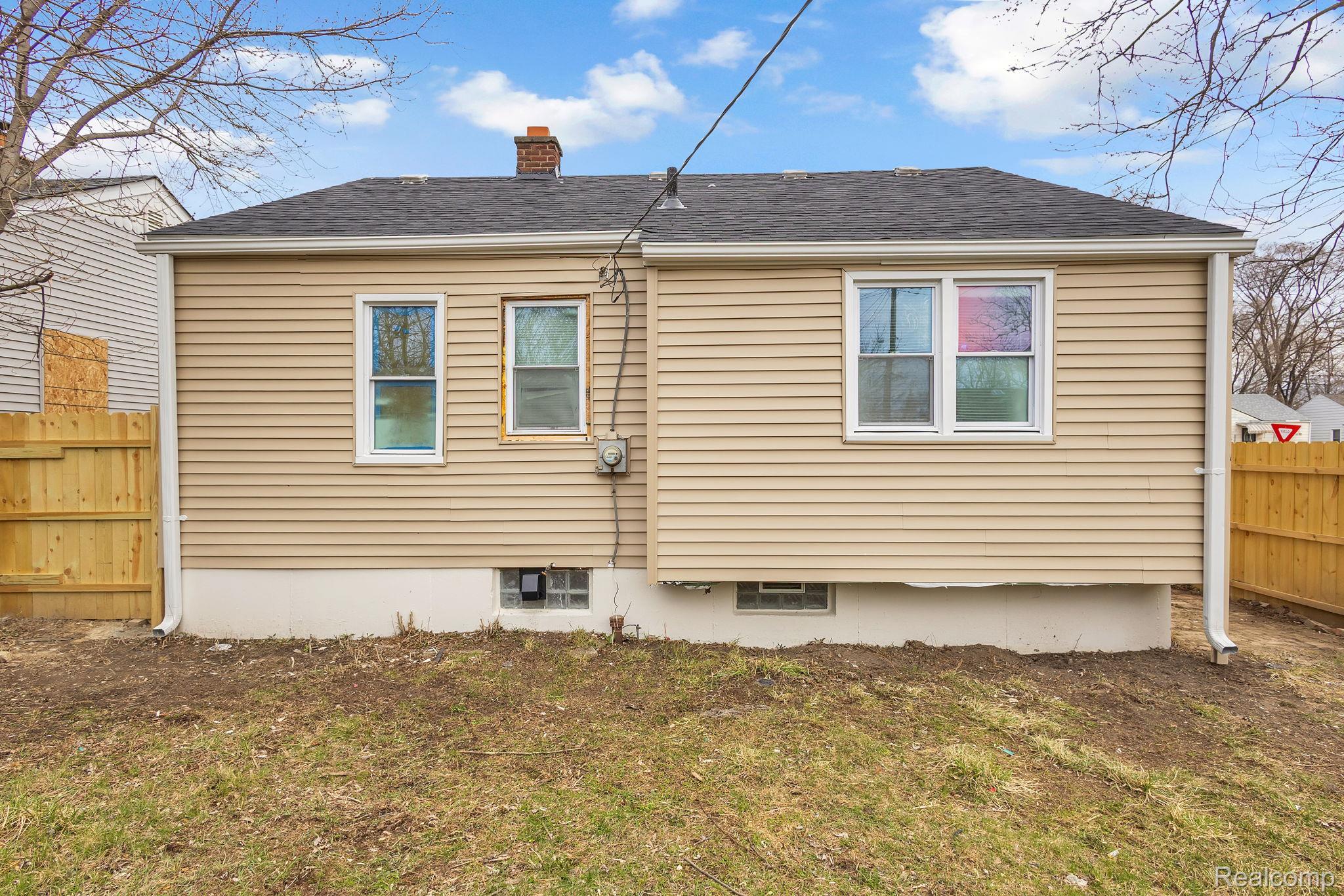 8401 Fielding Street Detroit, MI 48228 - Photo 31 of 34 View of side of home featuring a chimney and a shingled roof
