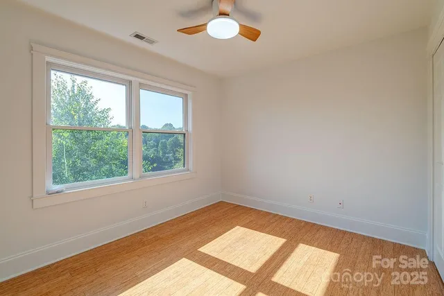 a view of room with window and ceiling fan