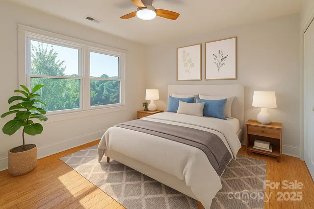a bedroom with bed and a potted plant