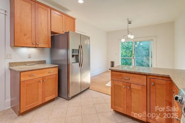 a kitchen with stainless steel appliances granite countertop a refrigerator sink and cabinets