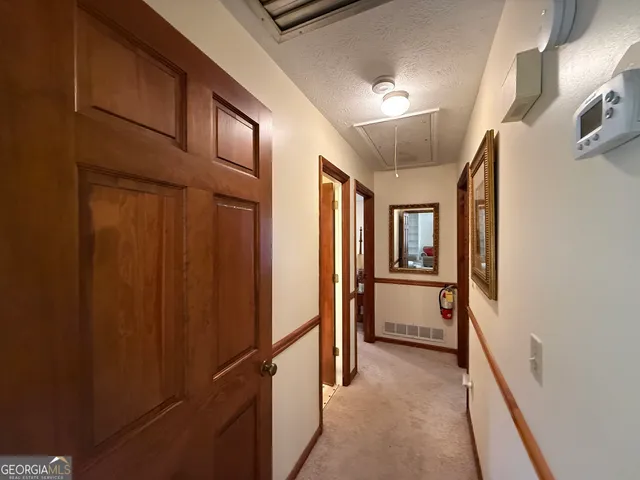 a view of hallway with chandelier