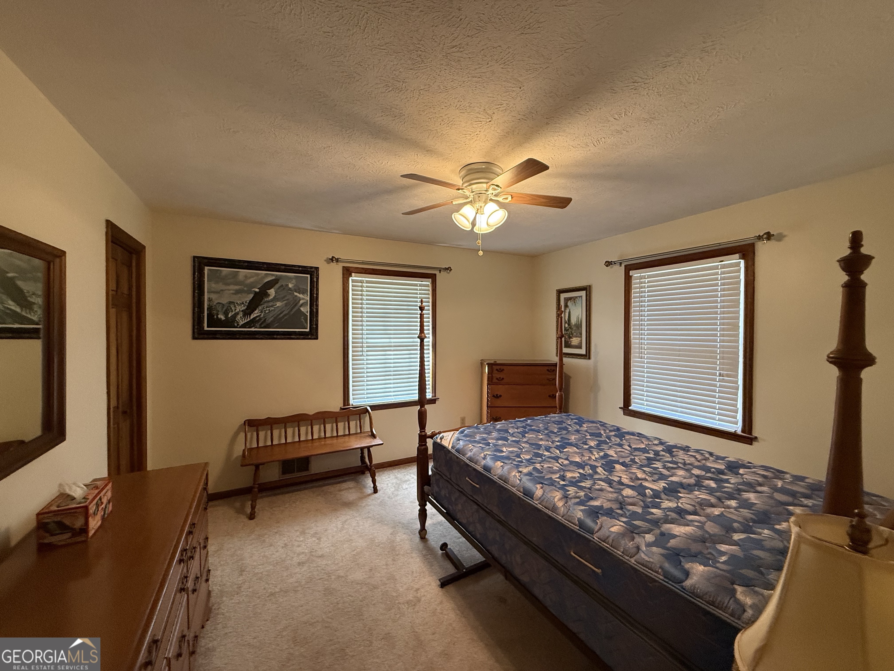 1084 Macedonia Road Newnan, GA 30263 - Photo 15 of 24 a bedroom with a bed and a chandelier