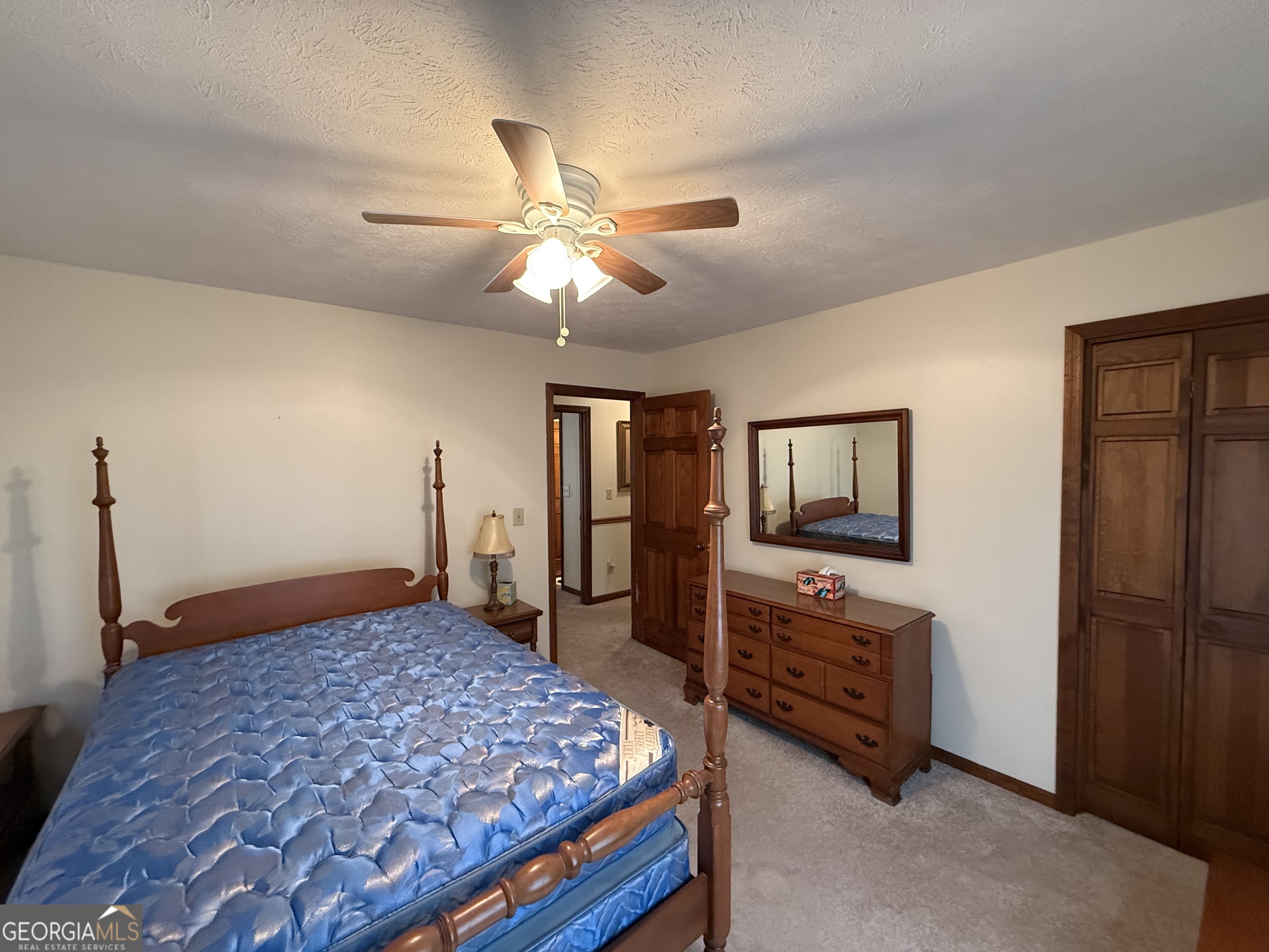 1084 Macedonia Road Newnan, GA 30263 - Photo 16 of 24 a bedroom with furniture and a flat screen tv