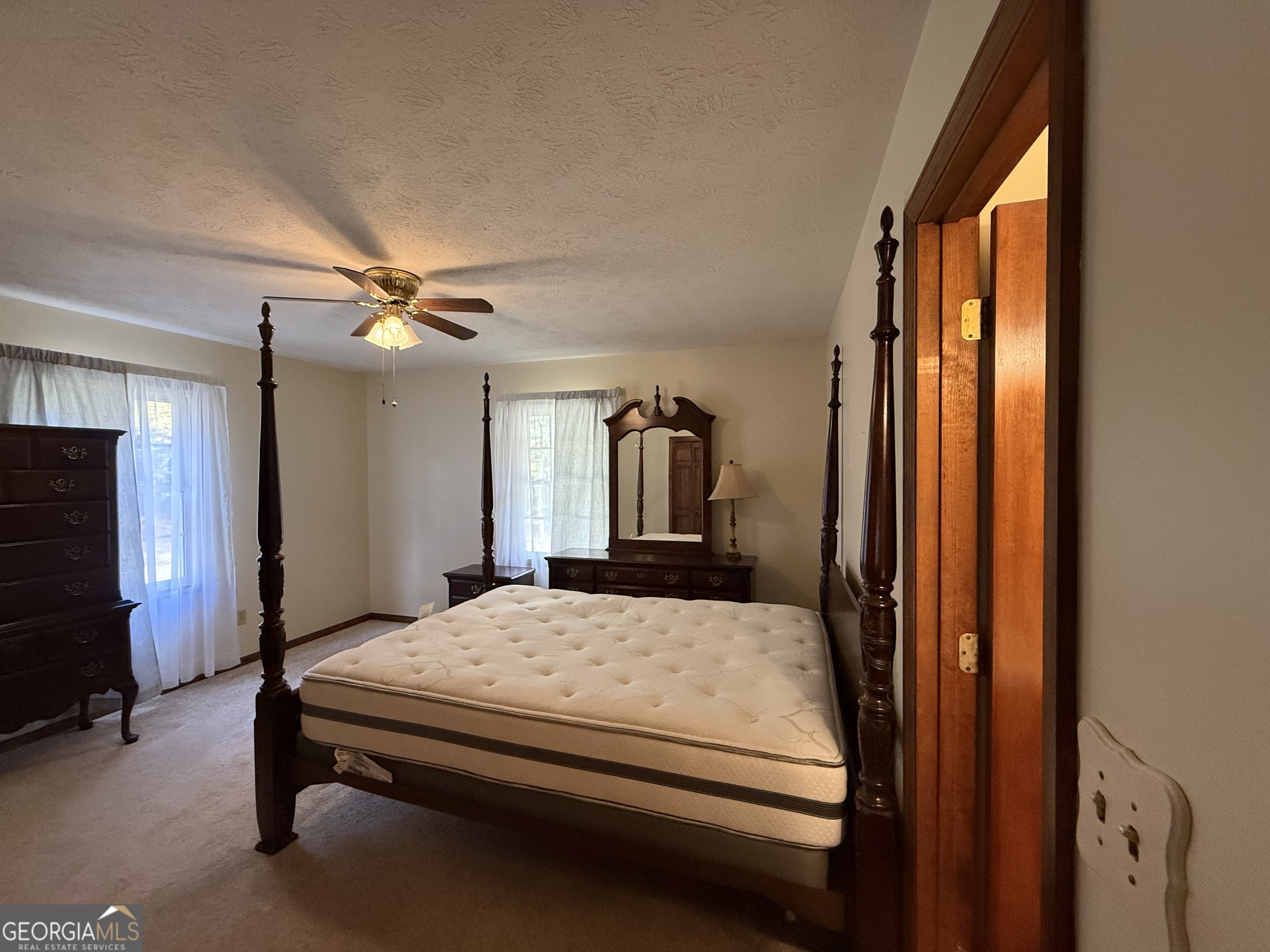 1084 Macedonia Road Newnan, GA 30263 - Photo 17 of 24 a bedroom with a bed and a chandelier