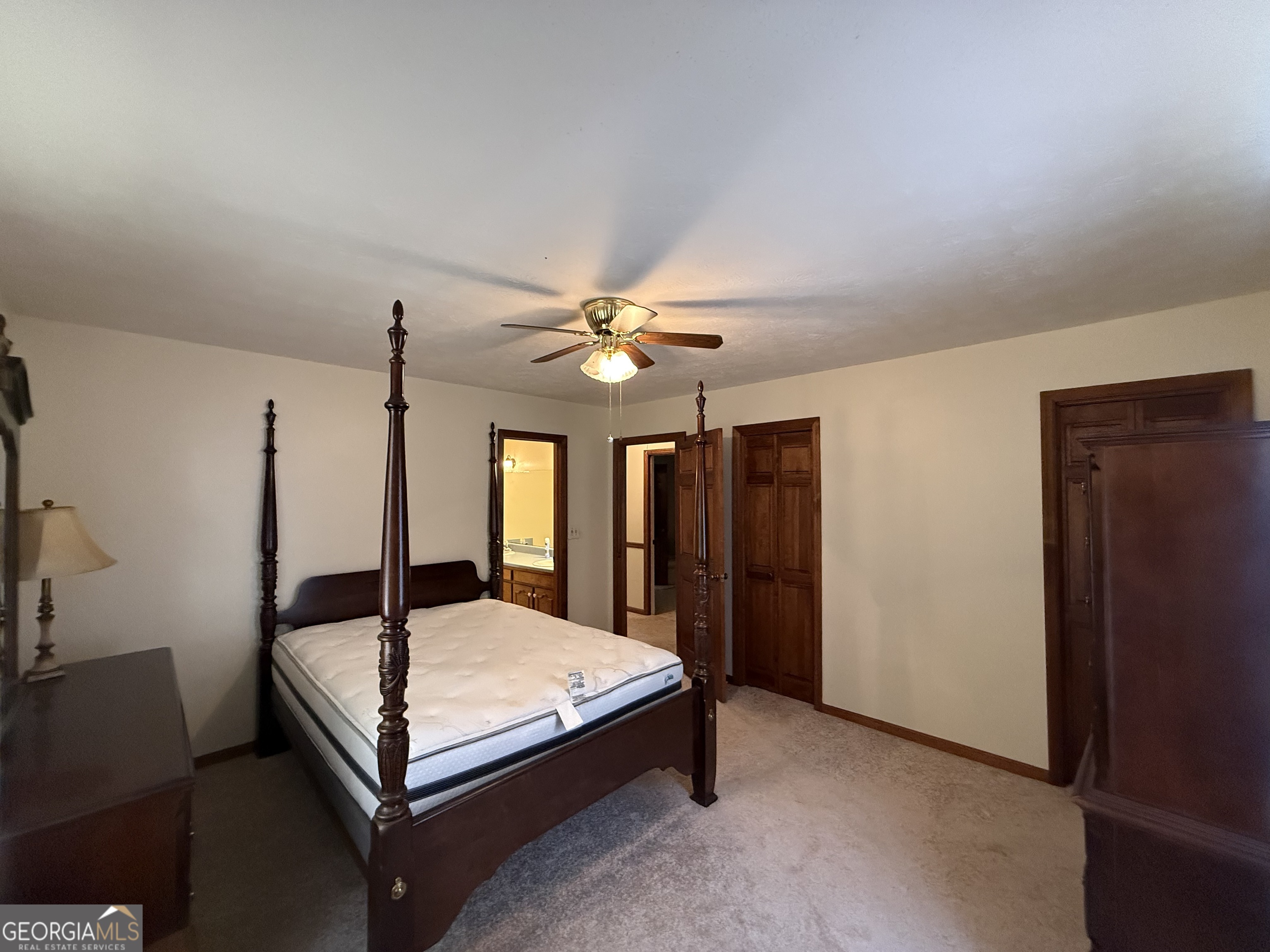 1084 Macedonia Road Newnan, GA 30263 - Photo 18 of 24 a bedroom with a bed and a chandelier