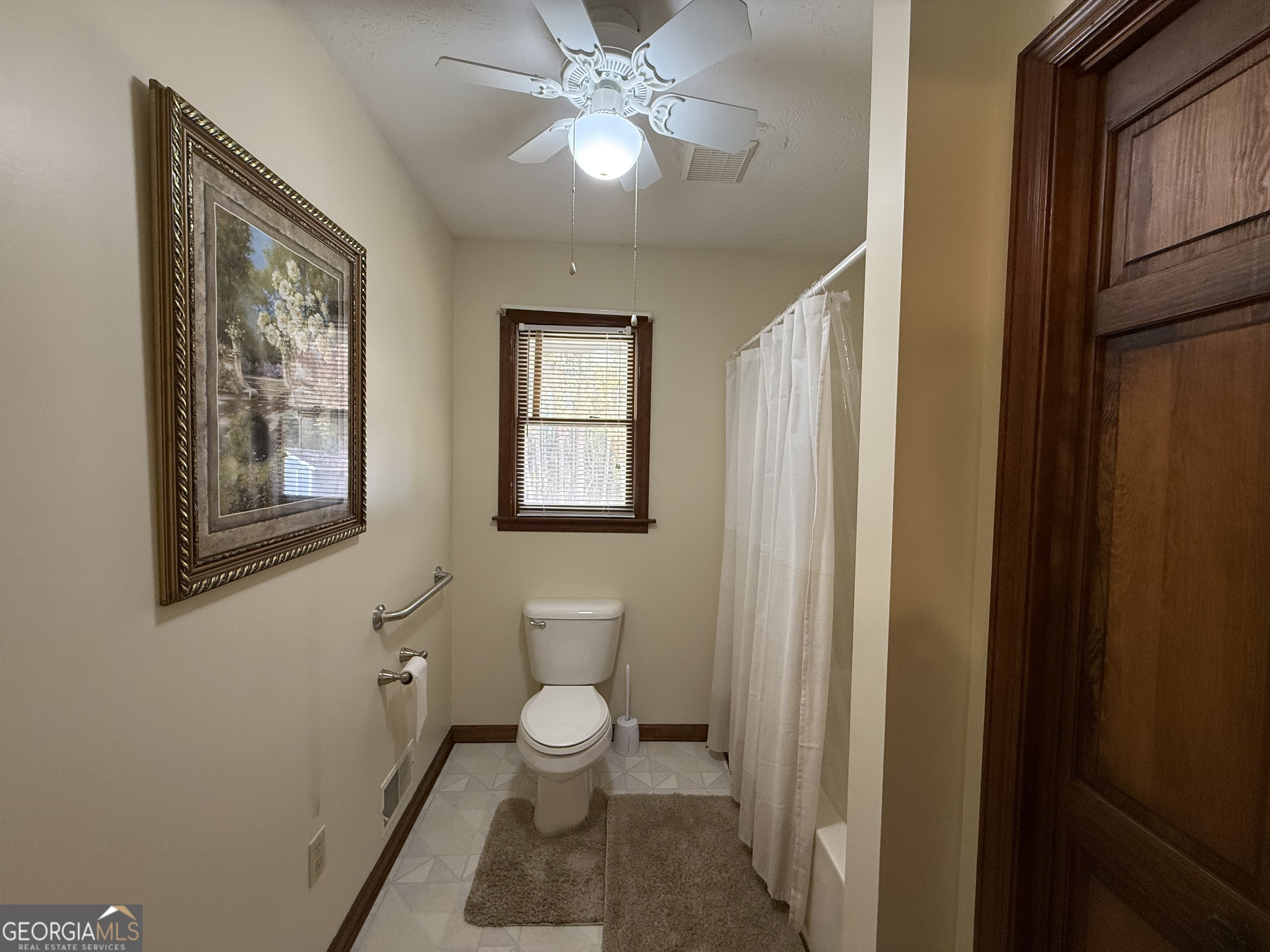 1084 Macedonia Road Newnan, GA 30263 - Photo 20 of 24 a bathroom with a toilet sink and a mirror