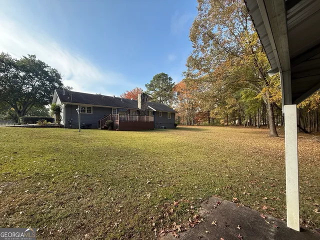 a view of house with yard