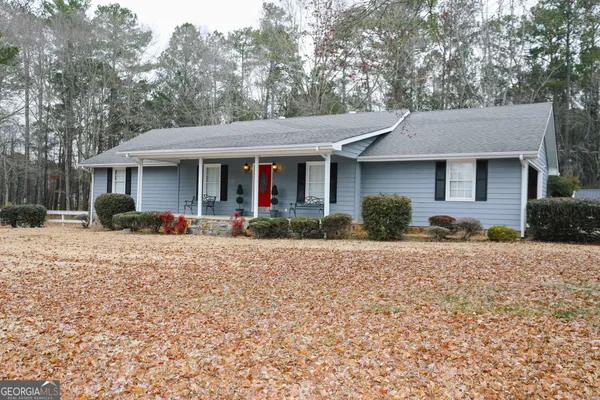a front view of a house with yard and potted plants