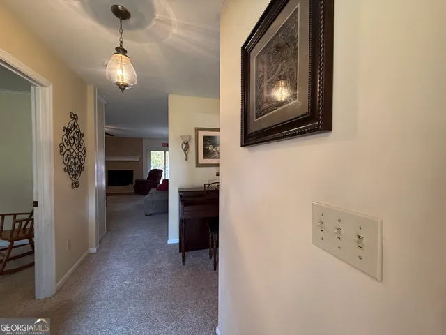 a view of a livingroom with furniture and a flat screen tv