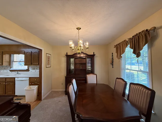 a view of a dining room with furniture window and outside view