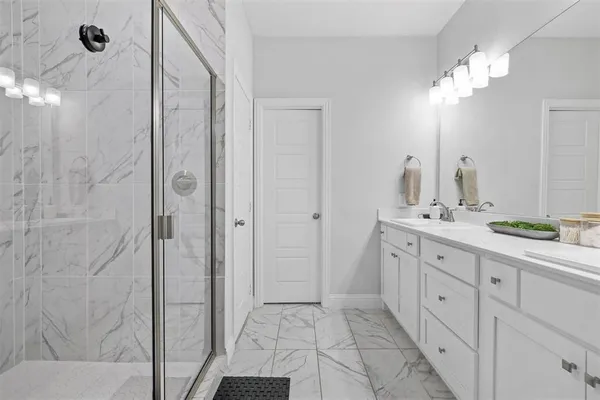 a bathroom with a double vanity sink and a mirror
