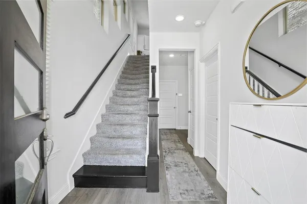 a view of entryway and hall with wooden floor
