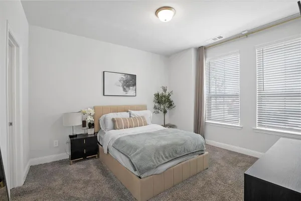 a bedroom with a large bed and a window