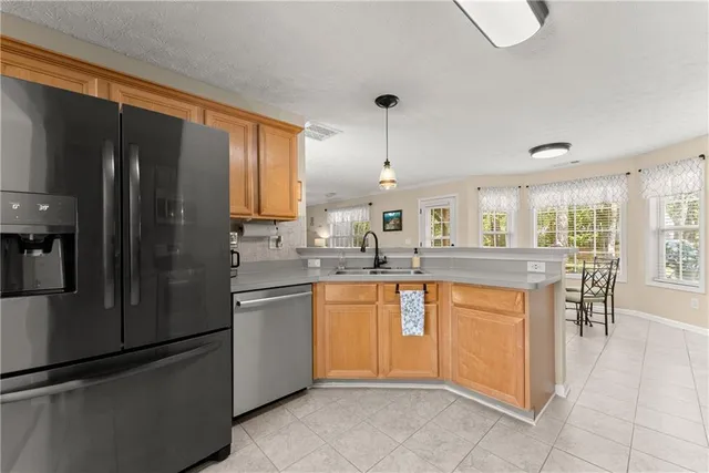 a kitchen with stainless steel appliances granite countertop a refrigerator stove and microwave