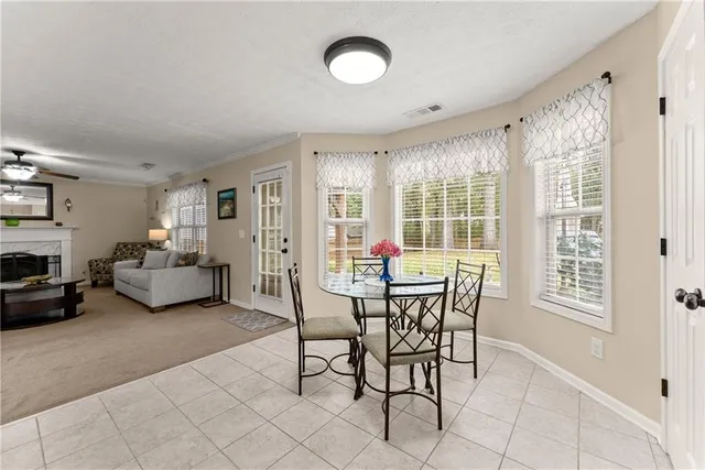 a dining room with furniture and window