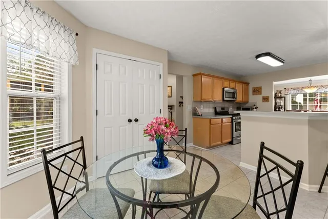 a kitchen with stainless steel appliances kitchen island granite countertop a refrigerator and cabinets