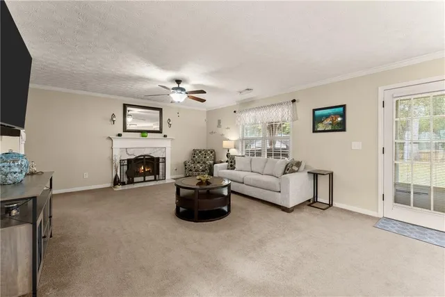 a living room with furniture a fireplace and a flat screen tv