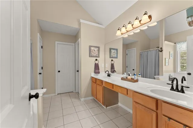 a bathroom with a tub shower and a sink