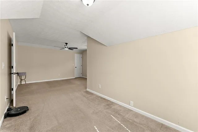 a view of a workspace with furniture and a ceiling fan