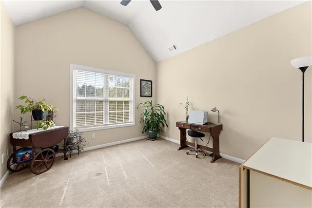 a view of a white house with a big yard and large trees