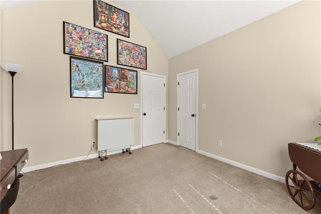 a front view of a house with a big yard and large trees