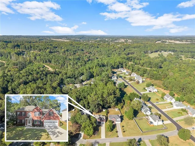 a view of a swimming pool with a lawn chairs under an umbrella