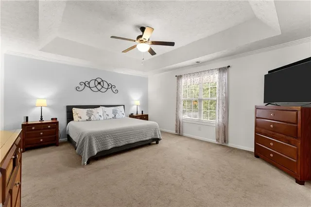 a bedroom with a bed and a television